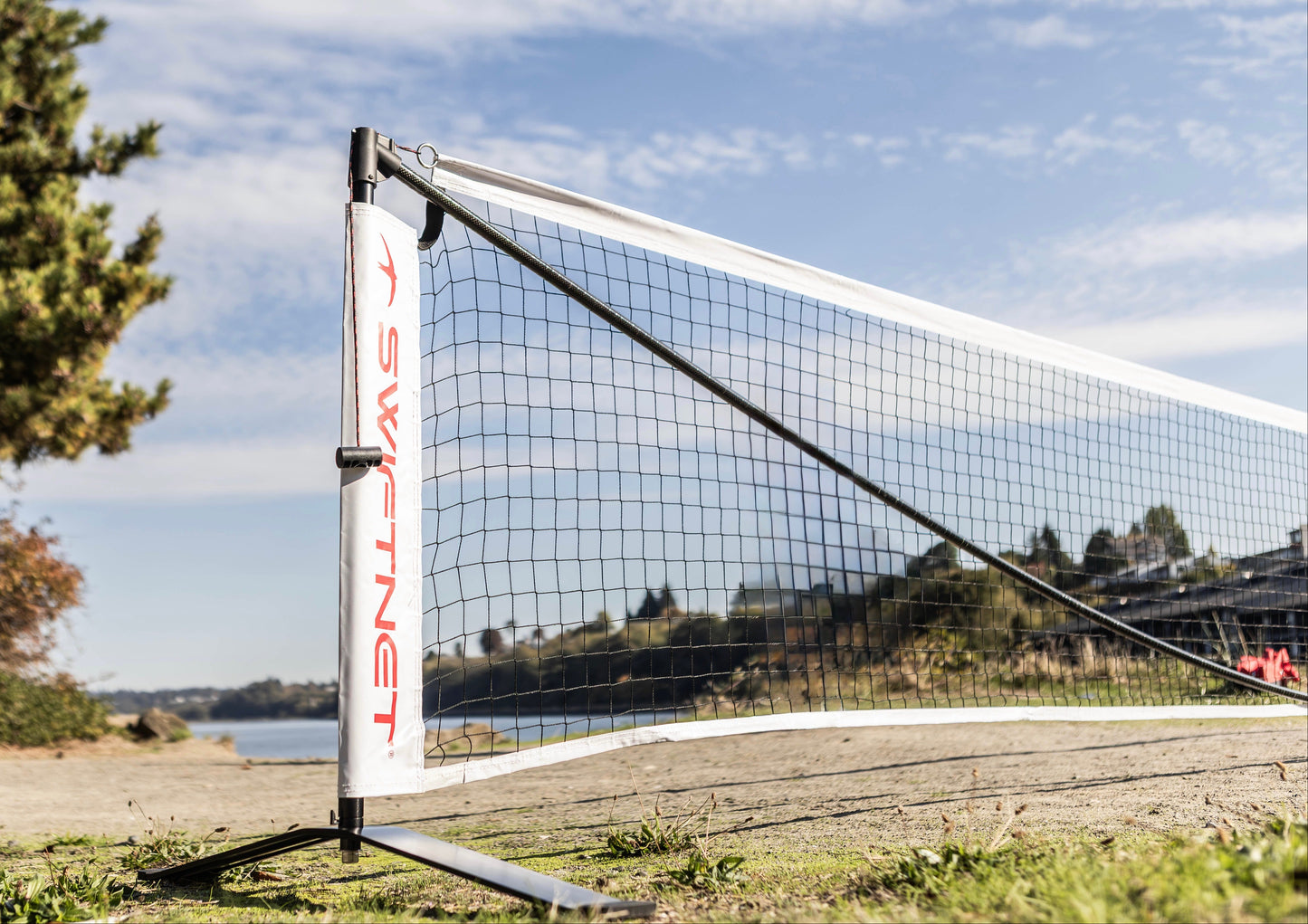 Pickleball net with "SwiftNet' branding, located on a northwest beach.